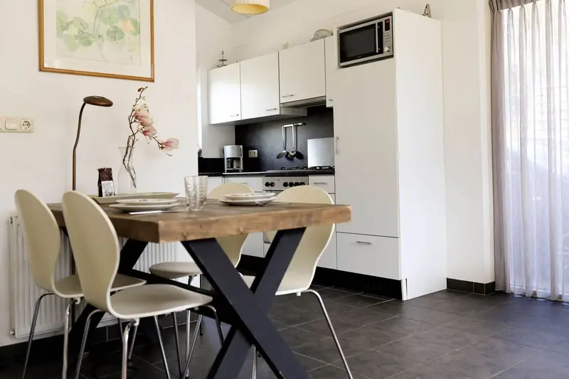 The dining table beside the open-plan kitchen of cottage&nbsp;2.